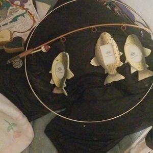 A metal fishing pole with  three picture frames